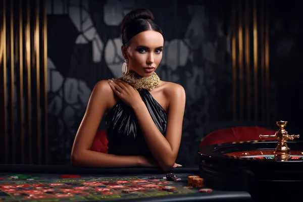 A stylish woman beside vibrant slot machines displaying glowing sevens, showcasing the variety of top slots at JLWILD.